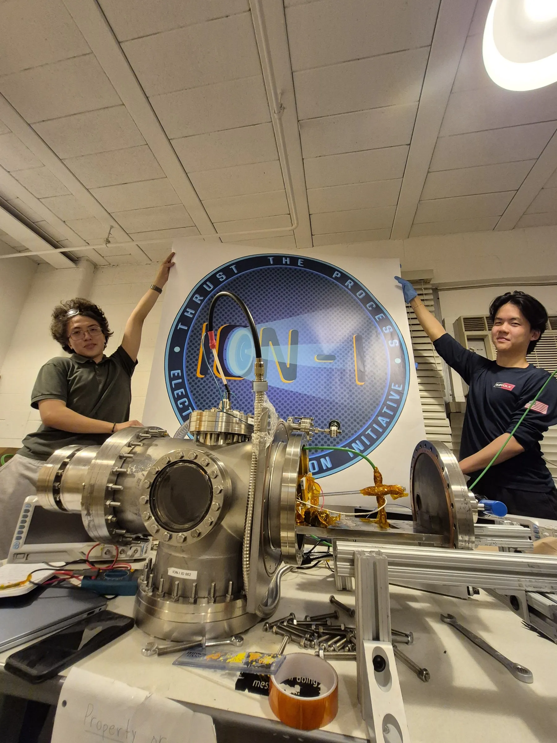 Team members assembling hardware under the ION-I banner