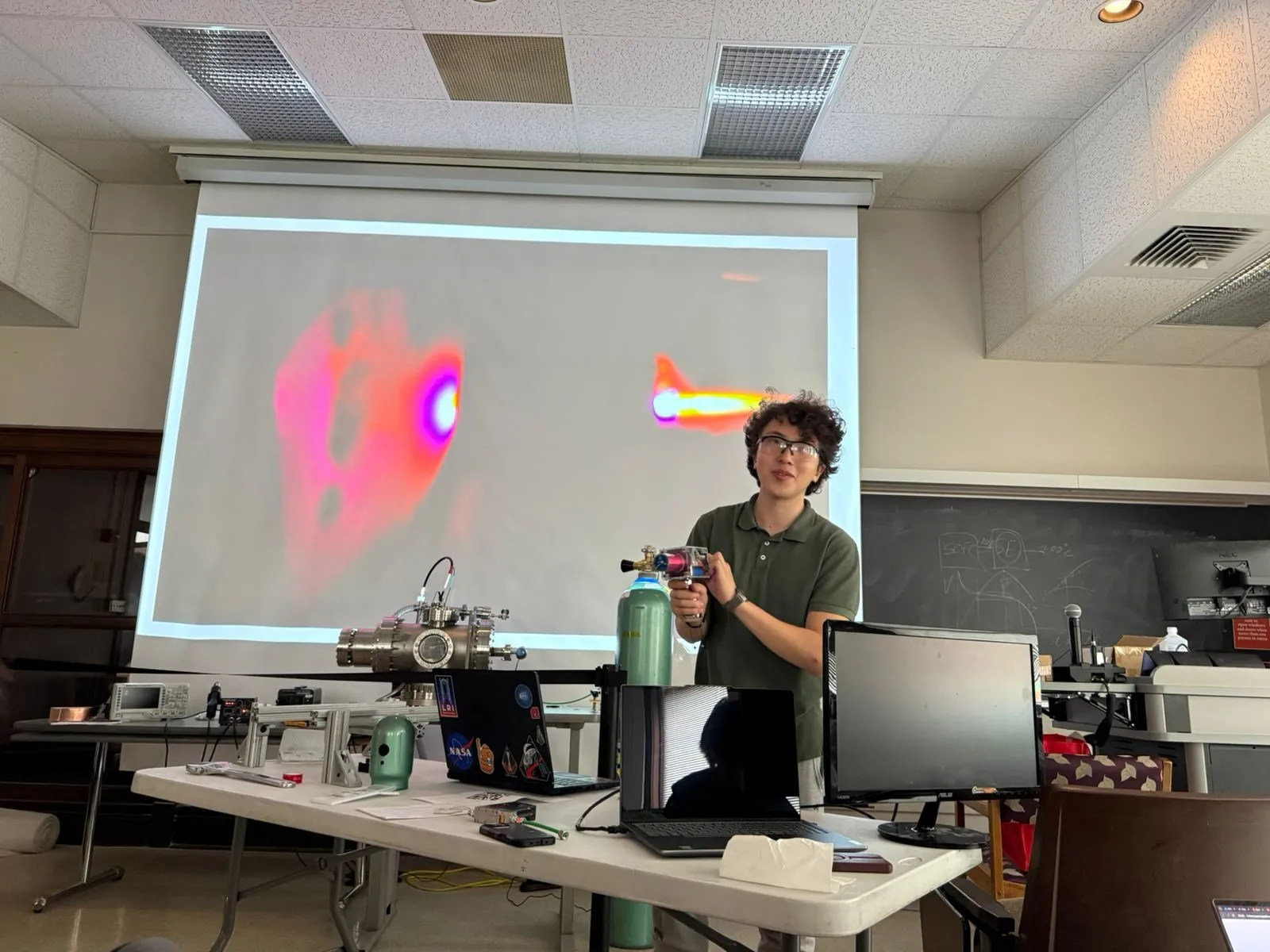 A member presenting in front of a projected simulation
