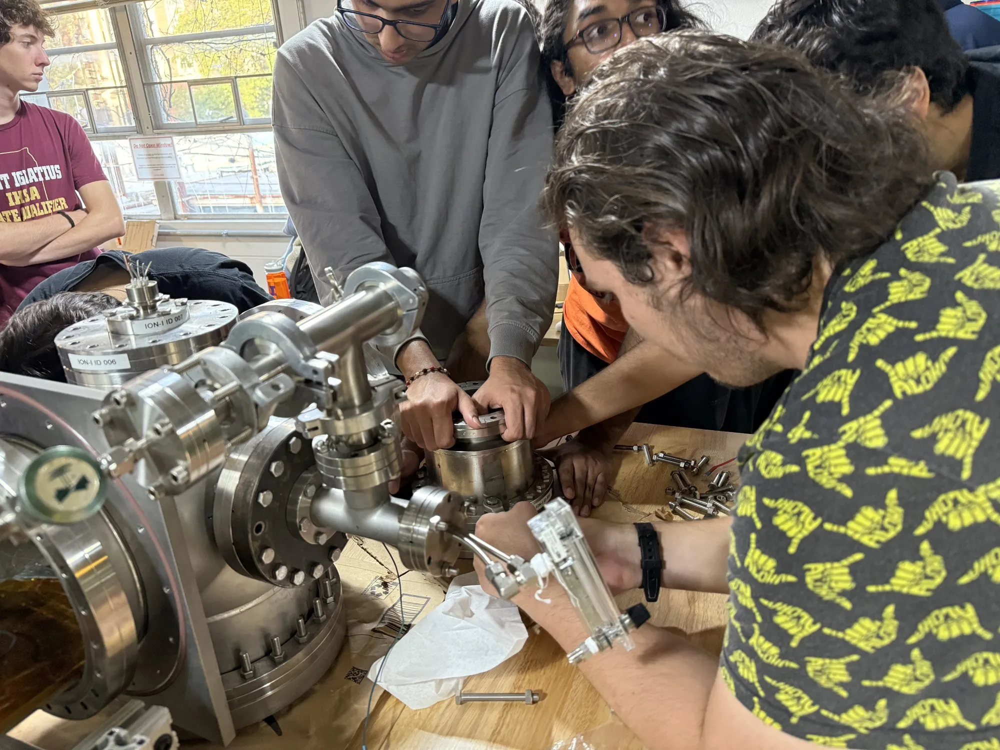 Members fitting parts onto the vacuum chamber ports