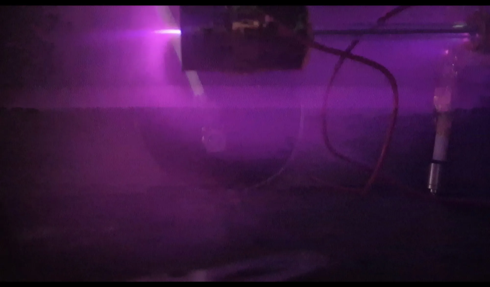 Purple argon glow inside the vacuum chamber