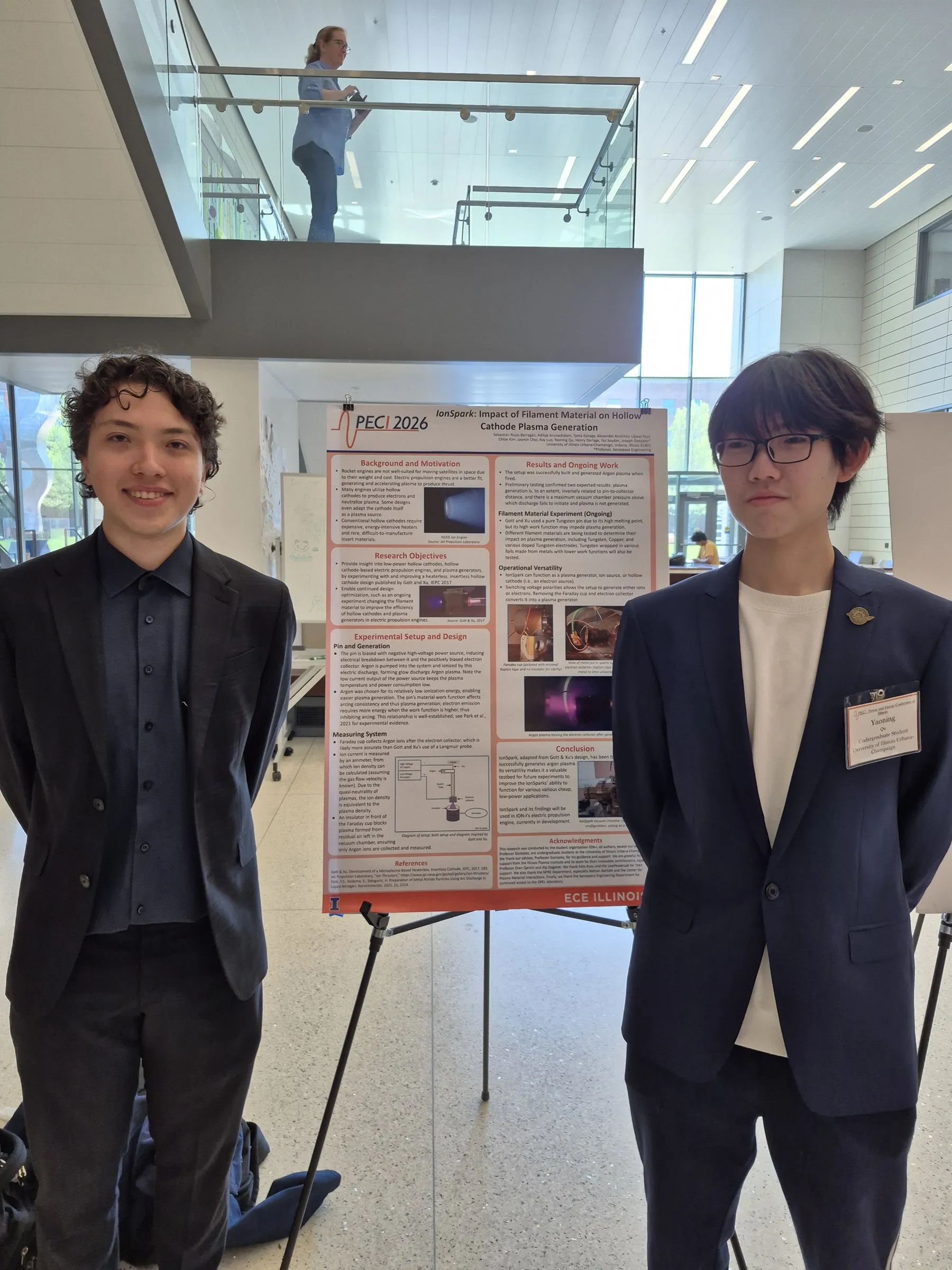 Two team members beside a research poster