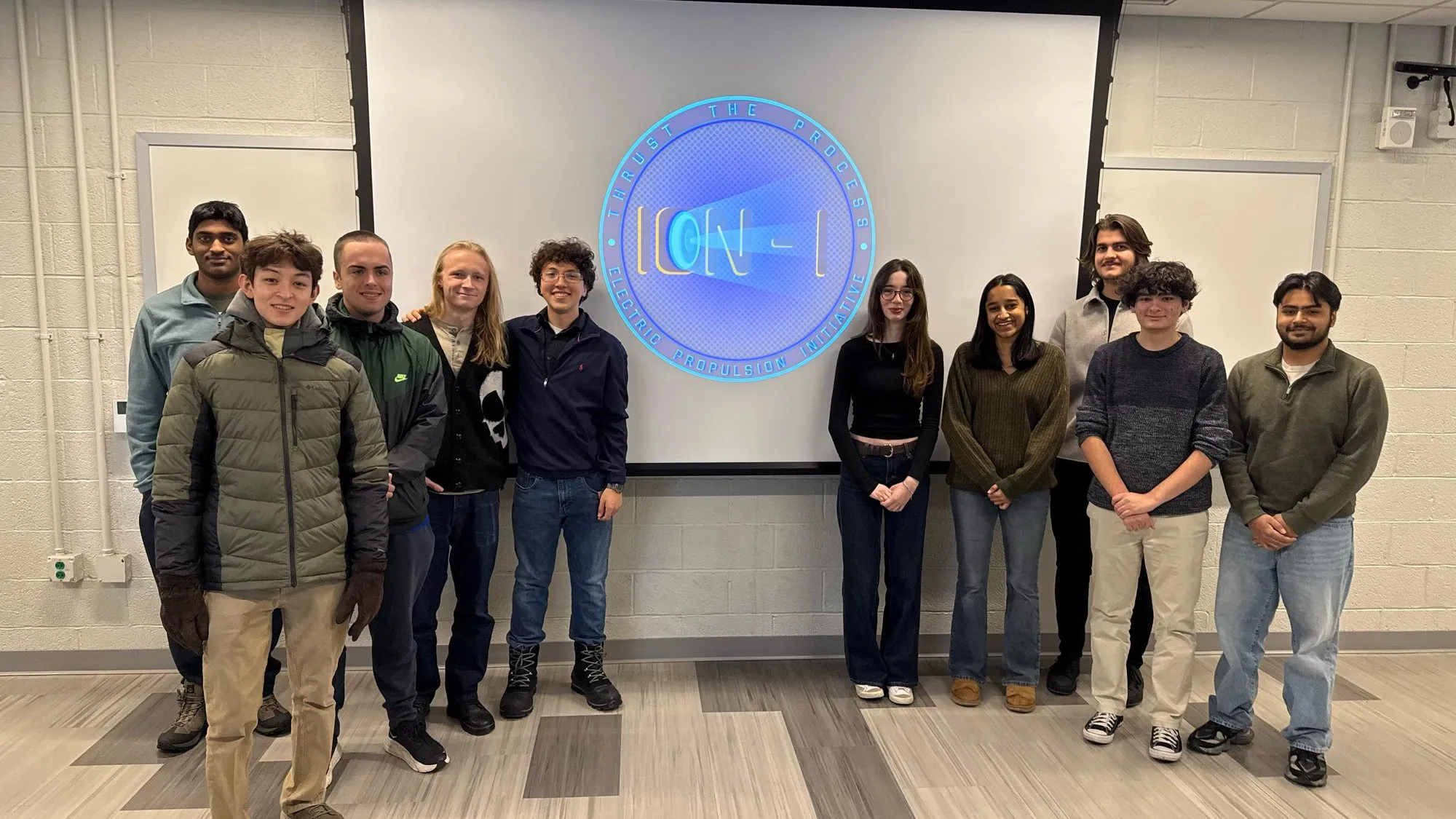 ION-I group photo in front of the club logo